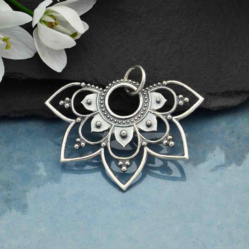 Sterling silver half mandala earrings.