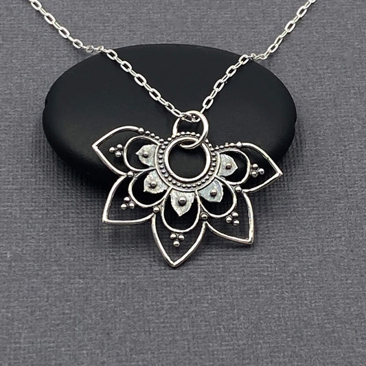 Half Mandala shaped silver pendant charm on a sterling silver chain that is dainty. 